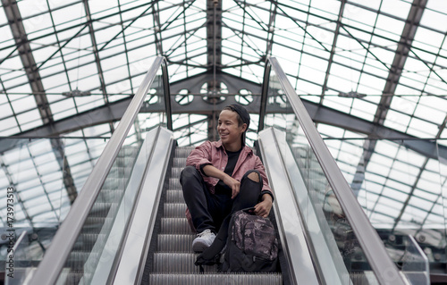 young man standing on the escalator rises