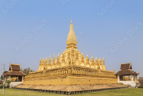 golden pagoda Phra That Luang public buddhist temple in Vientiane  Laos PDR under blue sky.                          