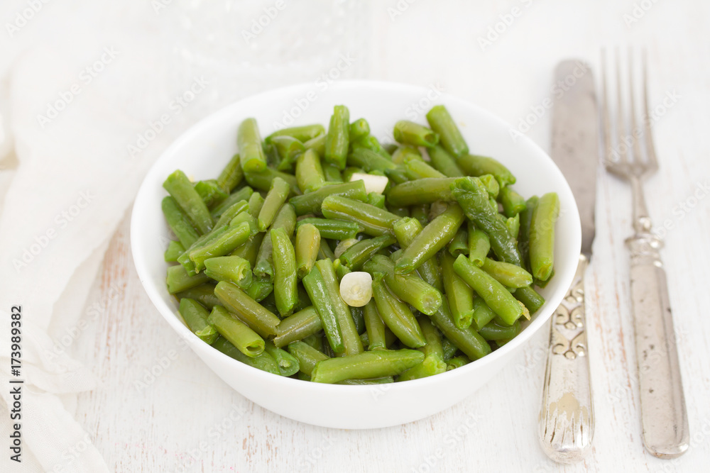boiled green beans with garlic in white bowl boiled green beans with garlic in white bowl