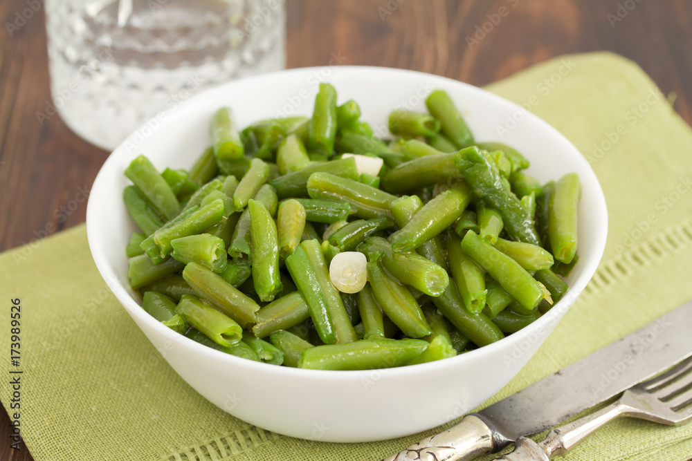 boiled green beans with garlic in white bowl boiled green beans with garlic in white bowl