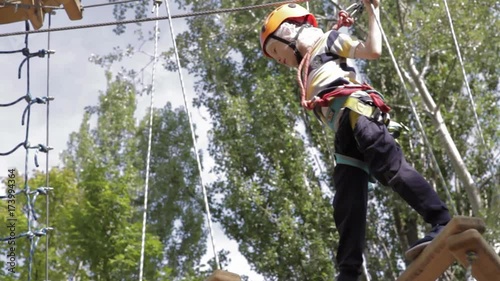 Wallpaper Mural Little cute boy enjoying activity in a climbing adventure park on a summer sunny day. toddler climbing in a rope playground structure. Safe Climbing extreme sport with helmet and Carabiner. insurance Torontodigital.ca