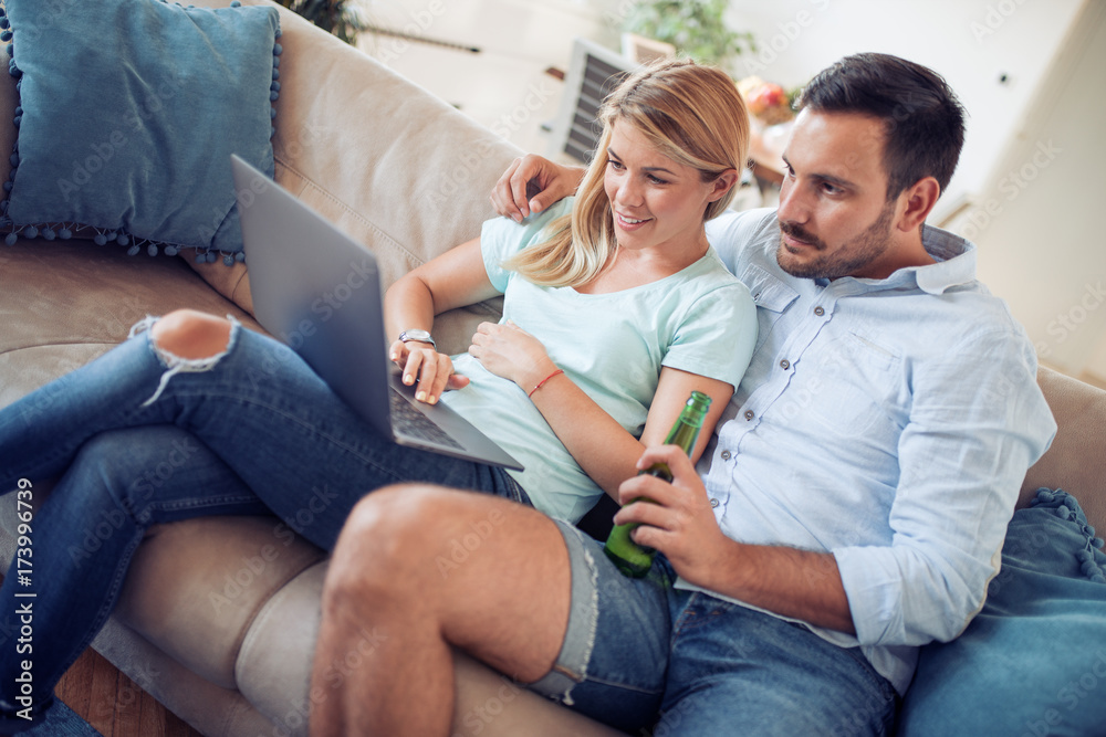 Couple on sofa with laptop
