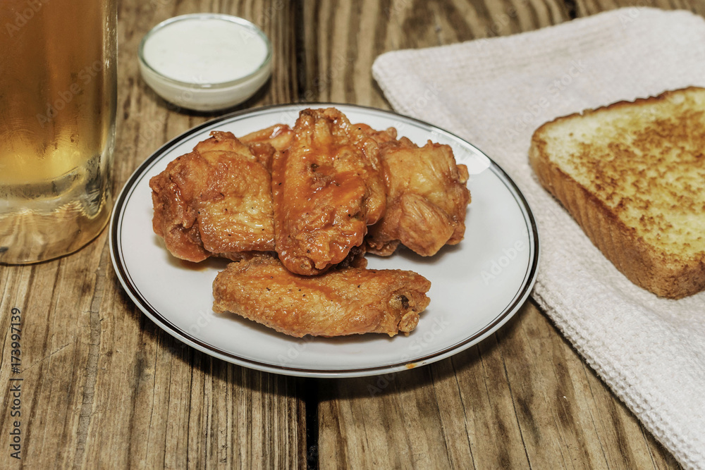 hot wings with toast and a cold beer on a wooden background hot wings with toast and a cold beer on a wooden background