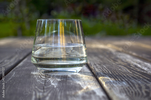 Glass of water on wood background