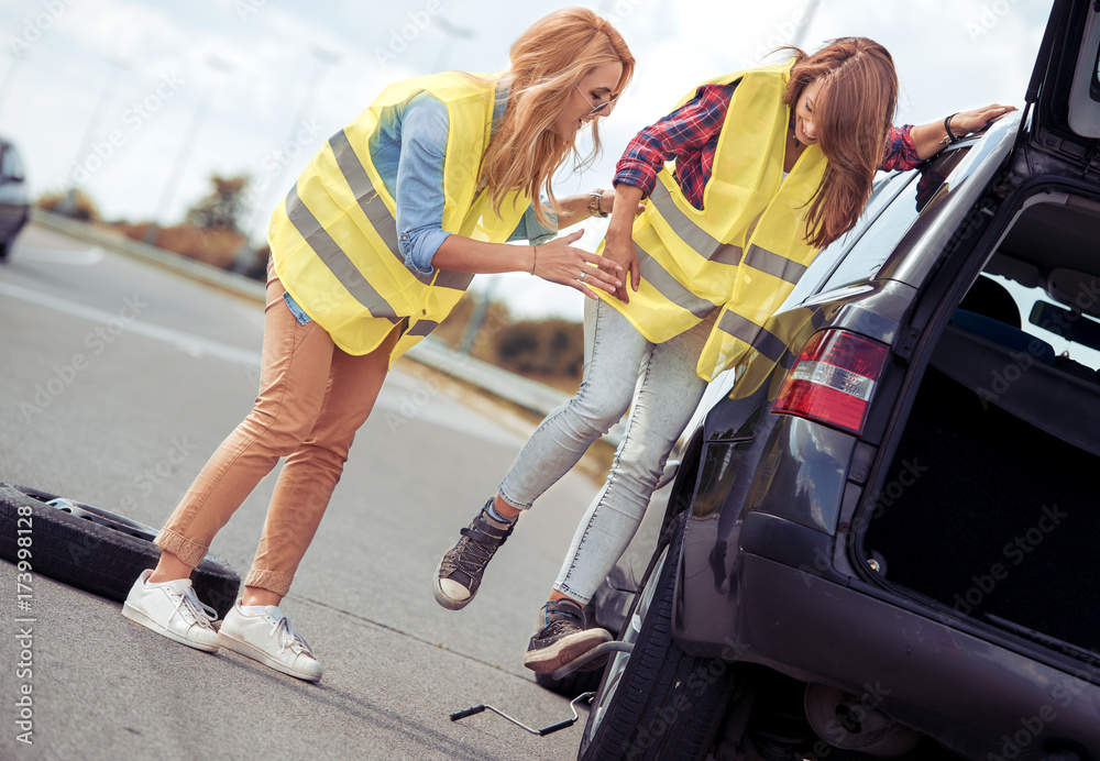 Fototapeta premium Girls having a problem with a car