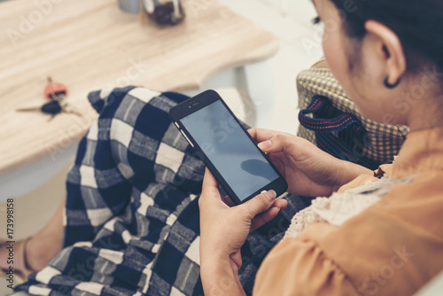 Young Asian beautiful woman using smart phone for business, online shopping, transfer money, financial, internet banking. in coffee shop.