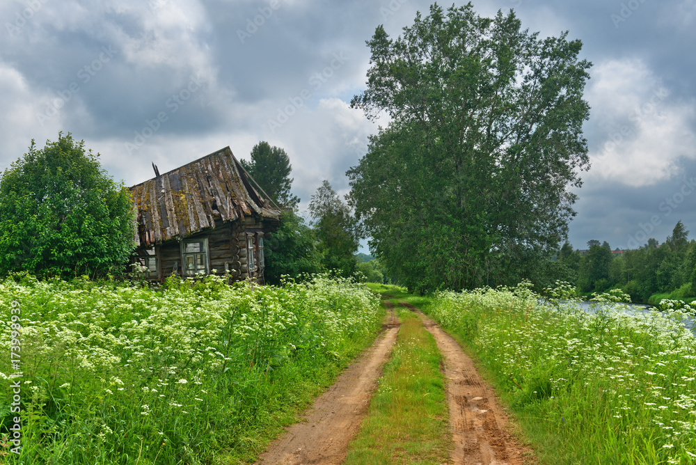 Abandoned village and a dirt road summer landscape. Abandoned village and a dirt road summer landscape.