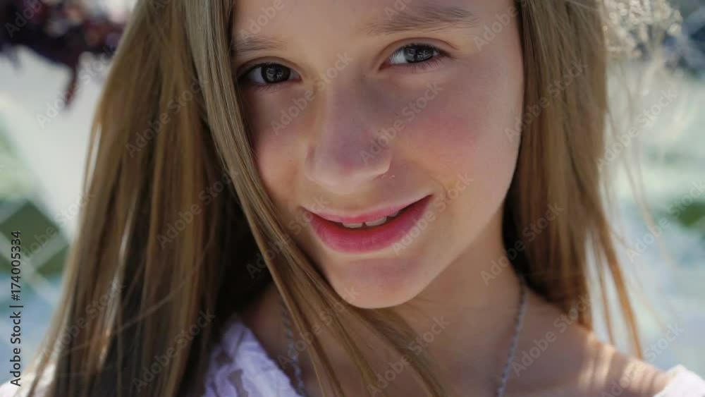 Portrait of happy little beautiful model looks at camera. Slowly Portrait of happy little beautiful model looks at camera. Slowly