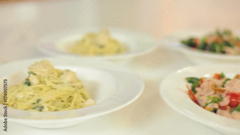 Bright colorful salad with bacon, with fresh arugula and tomatoes, spaghetti and delicious cake for dessert Bright colorful salad with bacon, with fresh arugula and tomatoes, spaghetti and delicious cake for dessert