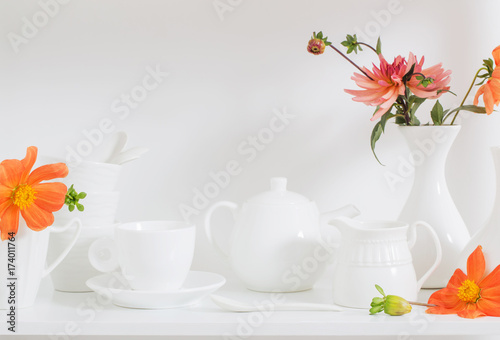 white dishware with flowers on wooden shelf