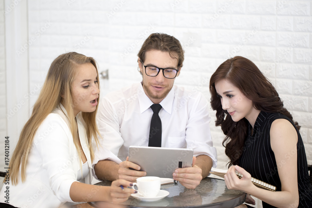 Businessman using Tablet for working at Cafe with team, People have a Meeting together at Cafe, People working concept Businessman using Tablet for working at Cafe with team, People have a Meeting together at Cafe, People working concept