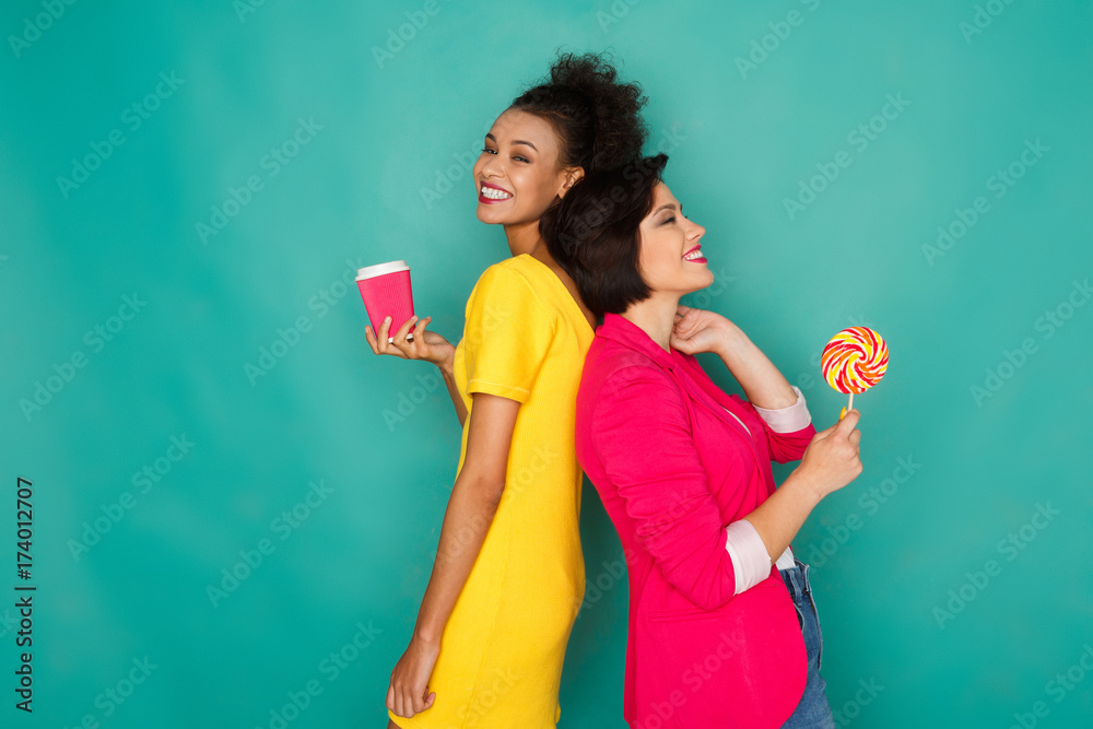 Joyful multiethnic women at azur studio background