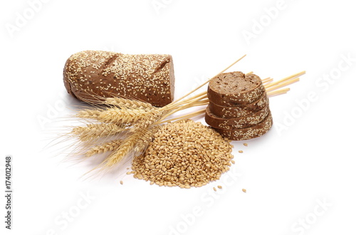 Whole wheat bread slices without additives, ears of wheat and grain isolated on white background