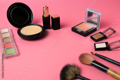 Cosmetic set for make-up artist and face care on pink background.