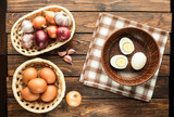 chicken eggs in basket decorated with food ingredients on wooden table