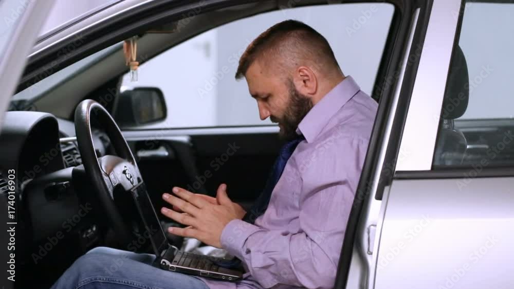 Businessman checking something on laptop while sitting in the car and receives good news
Businessman checking something on laptop while sitting in the car and receives good news