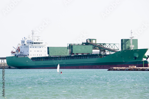  A cargo ship in port filling the warehouses