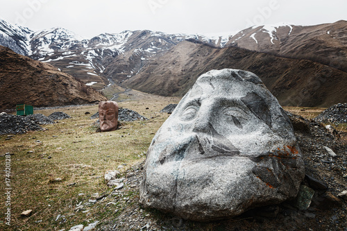 Stone face head in Sno valley in Georgia along the military road to Kazbegi photo