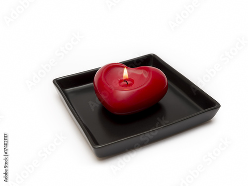 Red Heart Shaped Candle On A Black Plate, Isolated On White Background