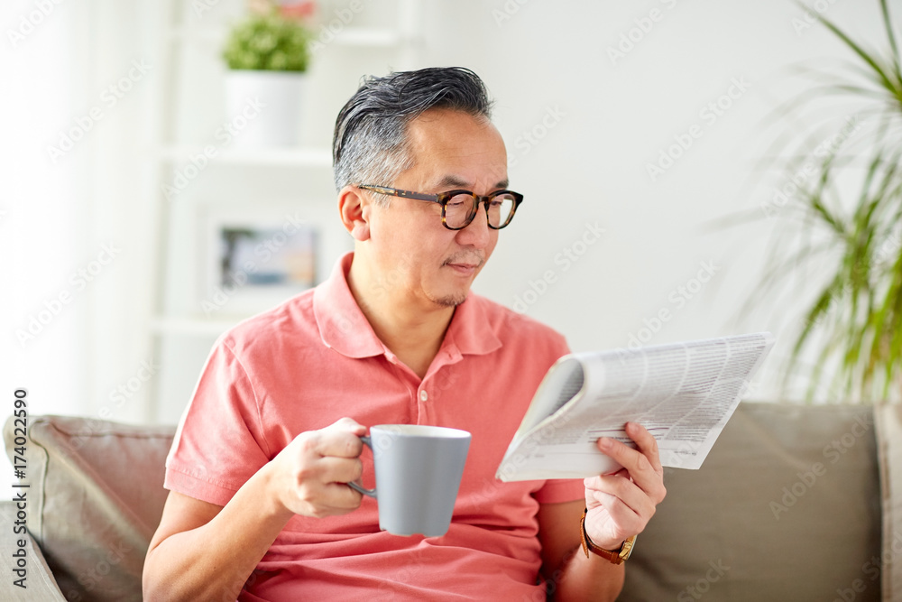 man drinking coffee and reading newspaper at home man drinking coffee and reading newspaper at home