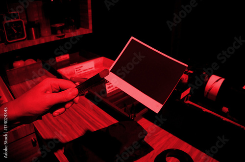 The manual process printingof old photos. Drying photos on rope