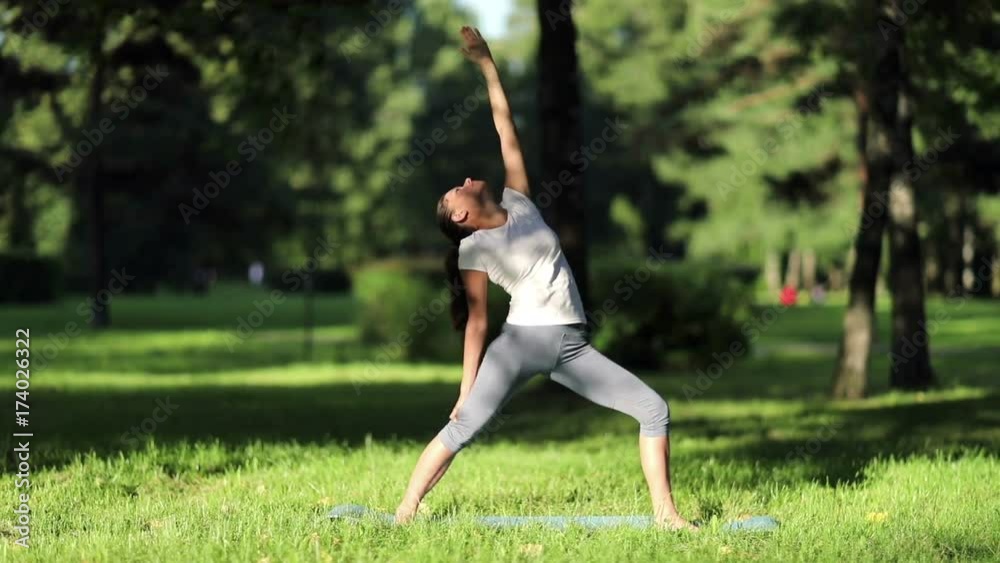 Woman practices yoga in the park. full HD 1080 50fps Woman practices yoga in the park. full HD 1080 50fps