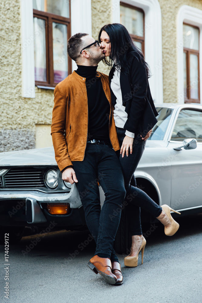 young couple kiss near the car young couple kiss near the car