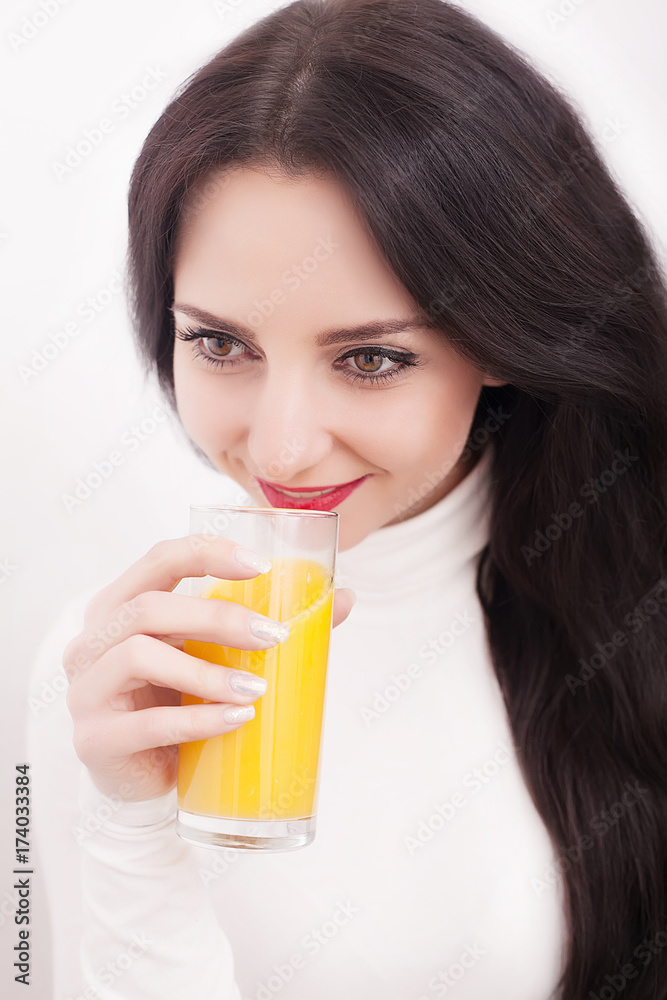 Young beautiful woman drinking orange juice on white background Young beautiful woman drinking orange juice on white background