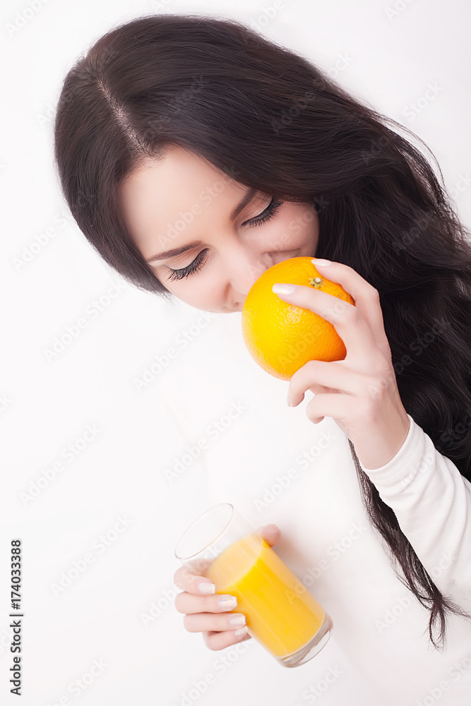Young beautiful woman drinking orange juice on white background Young beautiful woman drinking orange juice on white background