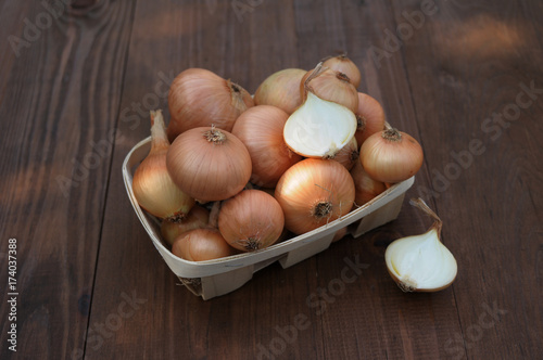 onion on a wooden table in a basket