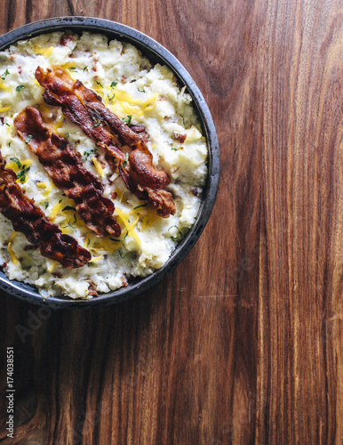 Twice baked mashed potato casserole covered with fried bacon, cheese and seasoning
