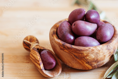 olives on wooden background, kalamata, kalamon, green olives photo