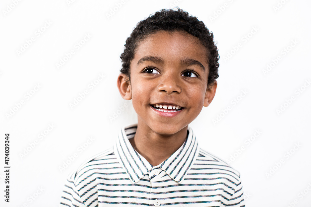 Portrait of a happy little boy over white background. Portrait of a happy little boy over white background.