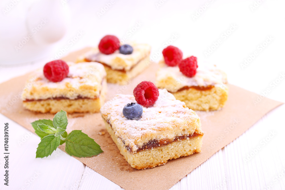 Homemade pie with berries cut into slices on a white background Homemade pie with berries cut into slices on a white background