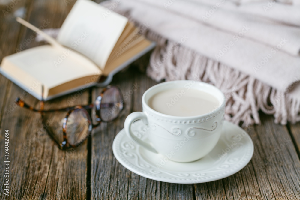 Fall evening with warm plaid< book and hot tea with milk Fall evening with warm plaid< book and hot tea with milk