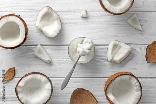 Composition with fresh coconut oil on wooden background