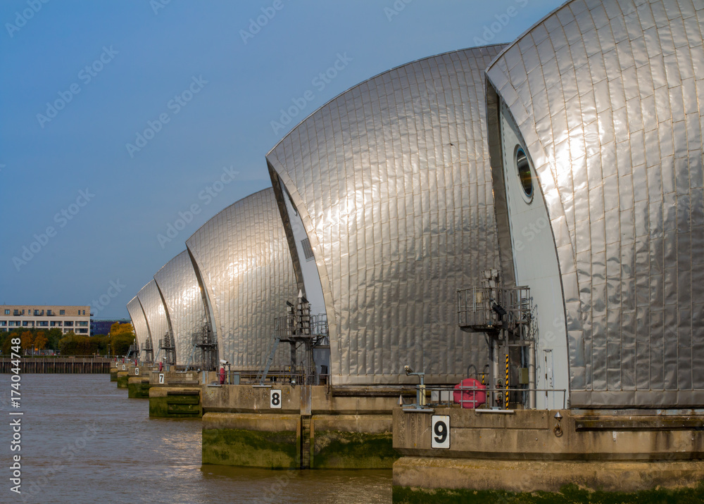 Obraz premium The metallic piers of the Thames Barrier line up, protecting London from flood.