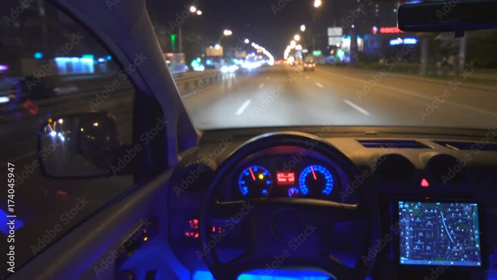 The autopilot drive a car in the city. night time, inside view The autopilot drive a car in the city. night time, inside view