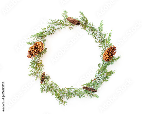 Christmas round frame made of evergreens and cones photo