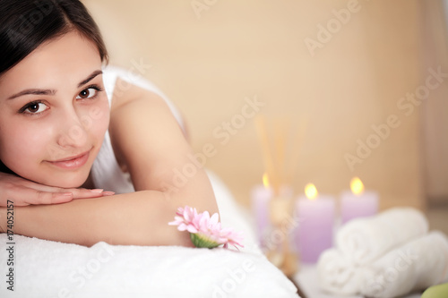 Cute young woman enjoying during a skin care treatment at a spa.