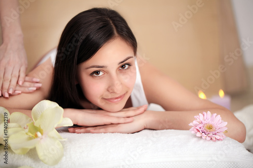 Masseur doing massage on woman body in the spa salon. Beauty treatment concept.