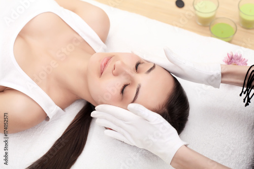 people, beauty, spa, healthy lifestyle and relaxation concept - close up of beautiful young woman lying with closed eyes in spa