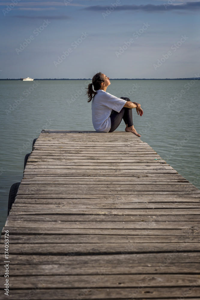Young girl out on the wooden pier