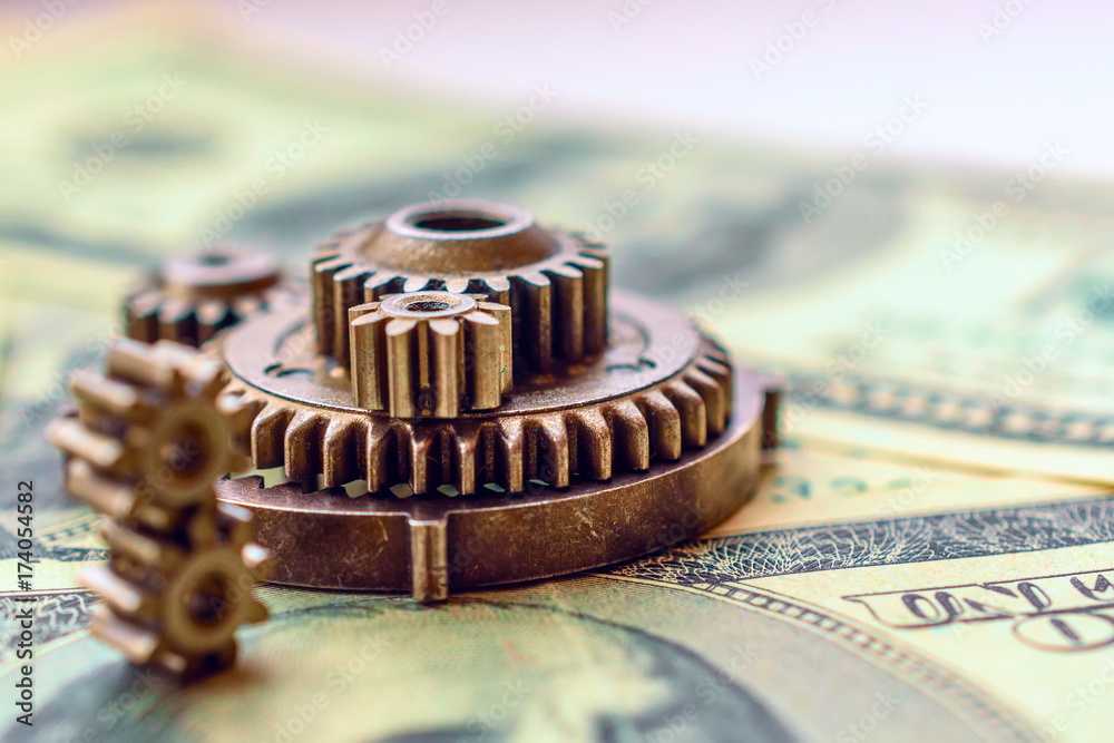 metal gears on dollar banknotes metal gears on dollar banknotes