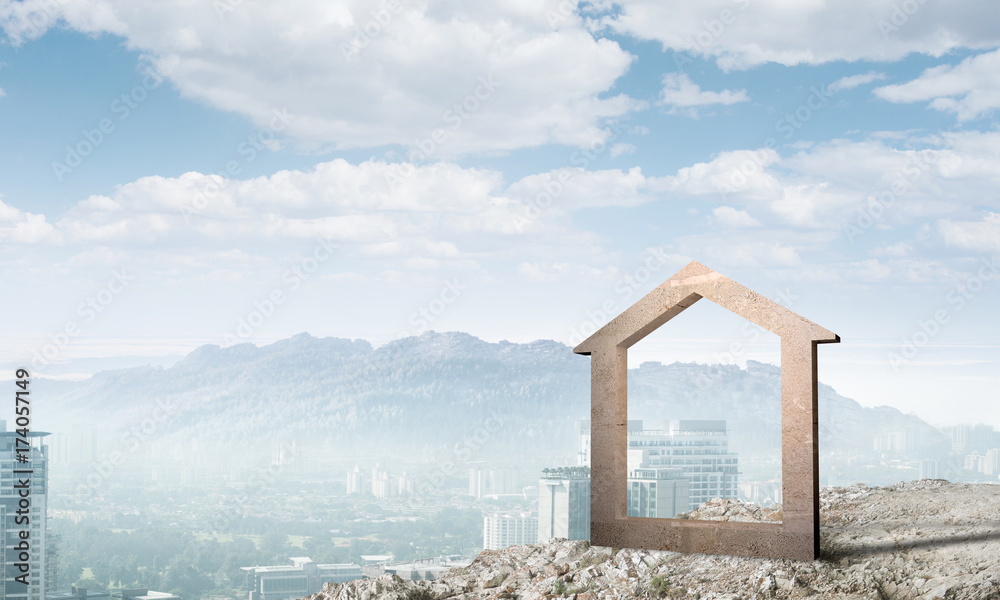 Conceptual image of concrete home sign on hill and natural landscape at background Conceptual image of concrete home sign on hill and natural landscape at background