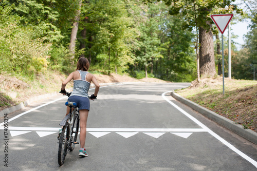 Wallpaper Mural Young Woman riding bicycle. Observance of traffic law Torontodigital.ca
