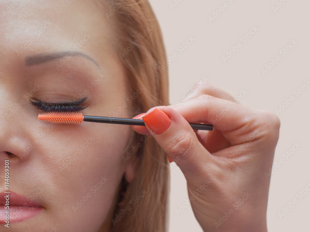 Beautiful Woman with long eyelashes in a beauty salon. Eyelash extension procedure. Lashes close up Beautiful Woman with long eyelashes in a beauty salon. Eyelash extension procedure. Lashes close up