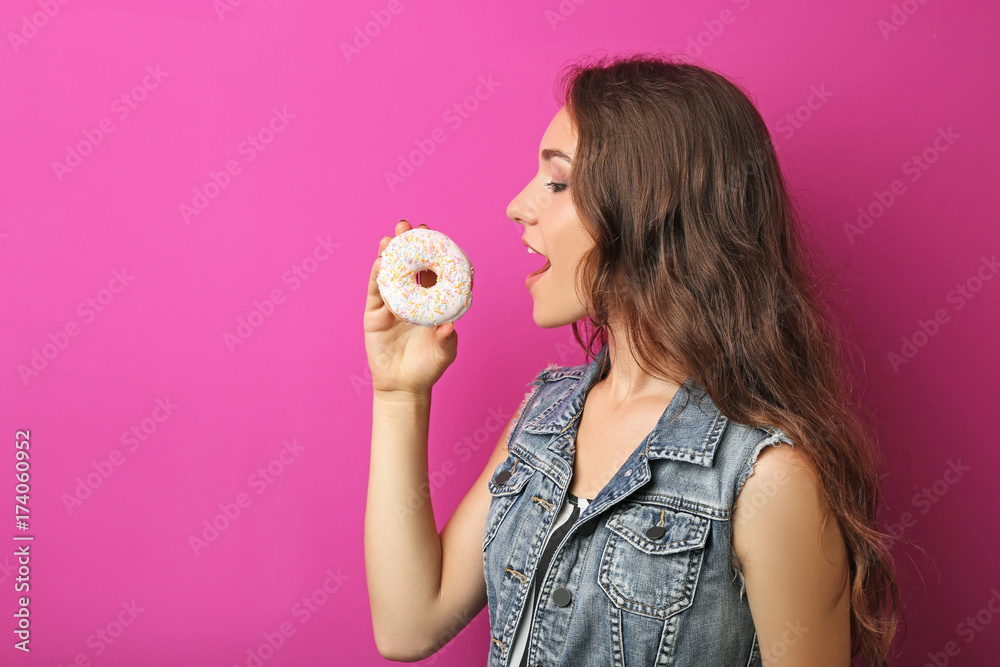 Portrait of young woman with sweet donut on pink background Portrait of young woman with sweet donut on pink background