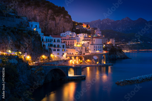 Night view of Amalfi cityscape on coast line of mediterranean sea, Italy