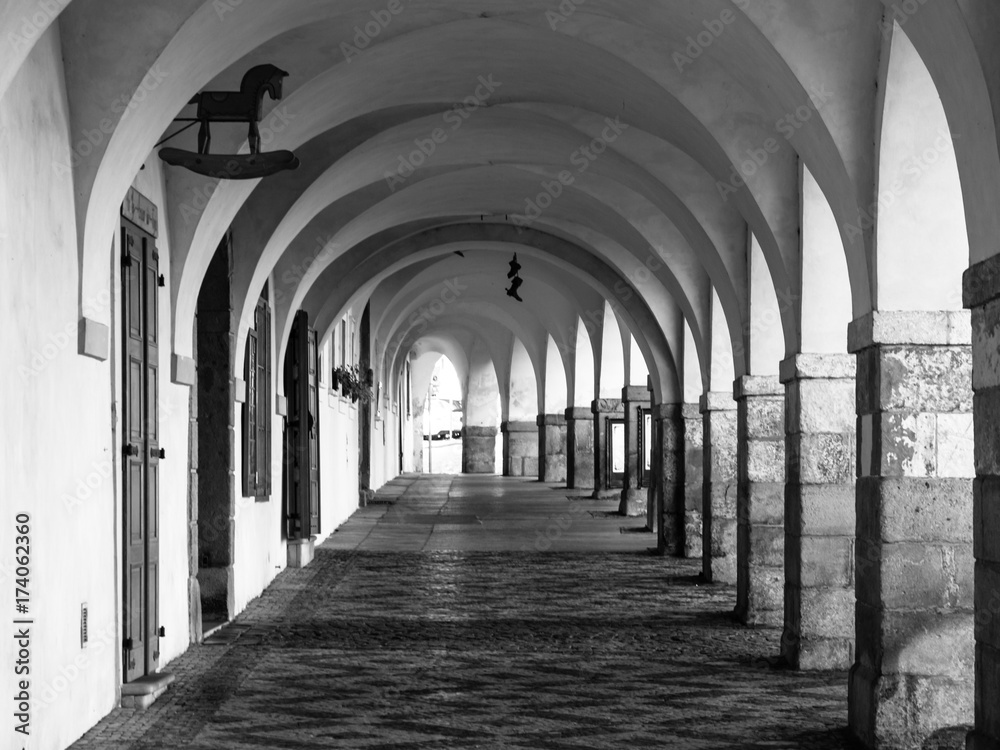 Old historical arcade in Loretanska Street near Prague Castle, Prague, Czech Republic. Black and white image